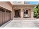 Charming home entrance with a stone porch, porch swing, and three-car garage at 5091 Hidden Pond Pl, Castle Rock, CO 80108