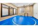 This is a gym space with padded blue flooring, mirrored walls, and exercise equipment for a complete workout at 5091 Hidden Pond Pl, Castle Rock, CO 80108