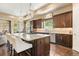 Stylish kitchen with granite countertops, dark wood cabinets, and stainless steel appliances at 5091 Hidden Pond Pl, Castle Rock, CO 80108