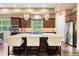 Kitchen island with bar seating, modern stainless steel appliances, and decorative pendant lighting at 5091 Hidden Pond Pl, Castle Rock, CO 80108