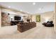 Spacious living room with a stone wall accent, fireplace, comfortable seating, and ample lighting at 5091 Hidden Pond Pl, Castle Rock, CO 80108