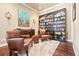 Charming living room with cozy seating, bookcase and a decorative rug creates a relaxing atmosphere at 5091 Hidden Pond Pl, Castle Rock, CO 80108
