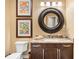 Stylish powder room featuring decorative art, a granite countertop, and modern fixtures at 5091 Hidden Pond Pl, Castle Rock, CO 80108