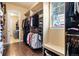 Large walk-in closet with ample storage space, built-in shelving, and convenient access to the laundry room at 5091 Hidden Pond Pl, Castle Rock, CO 80108