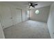 Bedroom with neutral carpet, ceiling fan, and ample closet space at 12166 Melody Dr # 202, Denver, CO 80234