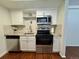 Updated kitchen with stainless steel appliances, granite countertops, and white cabinets at 12166 Melody Dr # 202, Denver, CO 80234