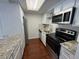 Well-maintained kitchen features granite countertops, white cabinets, and updated stainless appliances at 12166 Melody Dr # 202, Denver, CO 80234