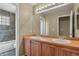 Bathroom features a double sink vanity with wood cabinets and a large mirror at 6533 S Ouray St, Aurora, CO 80016