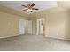 Bedroom featuring a ceiling fan, carpet, and access to the Primary bath at 6533 S Ouray St, Aurora, CO 80016