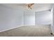 A spacious bedroom offers neutral carpet, light blue walls and a modern ceiling fan at 6533 S Ouray St, Aurora, CO 80016