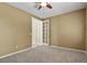 Comfortable bedroom with neutral walls and carpet, featuring a ceiling fan and closet at 6533 S Ouray St, Aurora, CO 80016