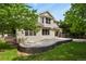 A charming home exterior with a patio perfect for entertaining, framed by vibrant greenery at 6533 S Ouray St, Aurora, CO 80016
