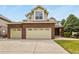 Charming two-story home featuring a brick facade and a spacious three-car garage at 6533 S Ouray St, Aurora, CO 80016