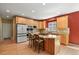 Open concept kitchen with island cooktop, stainless appliances, and recessed lighting at 6533 S Ouray St, Aurora, CO 80016