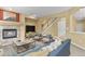 Digitally staged living room boasts a warm fireplace, comfortable seating, and stylish decor at 6533 S Ouray St, Aurora, CO 80016