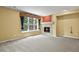 Sunlit living room with a fireplace and a large window offering a view of the green outdoors at 6533 S Ouray St, Aurora, CO 80016