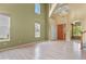 Open-concept living room with high ceilings, large windows, and hardwood floors at 6533 S Ouray St, Aurora, CO 80016