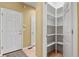 A walk-in pantry features open shelving for optimal storage and organization at 6533 S Ouray St, Aurora, CO 80016
