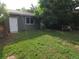Backyard featuring a storage shed, mature trees, and a lush lawn at 9075 W 66Th Ave, Arvada, CO 80004
