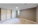 Finished basement space with carpet and closet with sliding doors at 9075 W 66Th Ave, Arvada, CO 80004