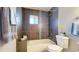 Modern bathroom with tiled walls and a bathtub and shower combination at 9075 W 66Th Ave, Arvada, CO 80004