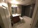 Well-lit bathroom features a shower-tub combo, dark tile, and mosaic accents at 9075 W 66Th Ave, Arvada, CO 80004