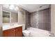Bathroom boasts tiled shower-over-tub, a modern vanity, and elegant finishes at 9075 W 66Th Ave, Arvada, CO 80004