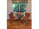 Cozy dining nook featuring a glass table, two chairs, and a decorative window at 9075 W 66Th Ave, Arvada, CO 80004