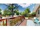 Cozy front porch with wood railings, blue outdoor seating, and a decorative rug at 9075 W 66Th Ave, Arvada, CO 80004