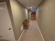 Inviting hallway featuring carpeted floors and stairs leading to the upper level at 9075 W 66Th Ave, Arvada, CO 80004