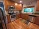 Well-lit kitchen featuring stainless steel appliances, light wood cabinets, and granite countertops at 9075 W 66Th Ave, Arvada, CO 80004