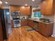 Well-equipped kitchen with stainless steel appliances, granite countertops, and wooden cabinets at 9075 W 66Th Ave, Arvada, CO 80004