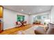 Sun-filled living room boasts hardwood floors and a neutral palette, creating a comfortable atmosphere at 9075 W 66Th Ave, Arvada, CO 80004