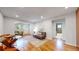 Bright and open floor plan with hardwood floors, connecting living, dining, and kitchen areas at 9075 W 66Th Ave, Arvada, CO 80004