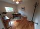 Well-lit office area with a wooden desk, chair, and decorative plants at 9075 W 66Th Ave, Arvada, CO 80004