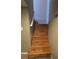 Interior staircase featuring wood steps and white handrail leading to the next level at 9075 W 66Th Ave, Arvada, CO 80004
