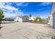 View of the home's rear exterior and a large concrete parking pad at 3249 W Alaska Pl, Denver, CO 80219