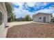 Cozy backyard with a mulch area, concrete slab, and partial view of the house at 3249 W Alaska Pl, Denver, CO 80219