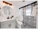 Modern bathroom featuring a stylish glass-enclosed shower with decorative tile and elegant fixtures at 3249 W Alaska Pl, Denver, CO 80219