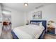 Cozy bedroom featuring white walls, wood-look floors, and stylish furnishings creating a tranquil personal space at 3249 W Alaska Pl, Denver, CO 80219