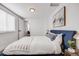 Comfortable bedroom with a striking blue bed frame, complemented by modern decor and natural light at 3249 W Alaska Pl, Denver, CO 80219