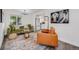 Modern living room with stylish furniture, decorative rug, and abundant natural light at 3249 W Alaska Pl, Denver, CO 80219