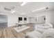 Expansive room filled with natural light, featuring comfortable seating, a desk area, and stylish decor at 3249 W Alaska Pl, Denver, CO 80219