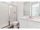 Modern bathroom featuring a glass enclosed shower, wood look floor and vanity at 9122 Telluride Ct, Commerce City, CO 80022