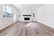 Bright living room with modern fireplace, wood floors, and lots of natural light at 9122 Telluride Ct, Commerce City, CO 80022