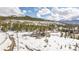 Aerial view of a luxury home nestled in a picturesque mountain landscape at 174 Sage Dr, Breckenridge, CO 80424