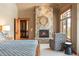 Comfortable bedroom featuring a stone fireplace and private ensuite bathroom at 174 Sage Dr, Breckenridge, CO 80424