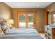 Bedroom featuring sliding doors to snowy views, and rustic wooden furnishings and trim at 174 Sage Dr, Breckenridge, CO 80424