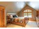 Comfortable bedroom with vaulted ceiling and serene wooded views at 174 Sage Dr, Breckenridge, CO 80424