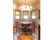 Charming dining nook with hardwood floors, decorative chandelier, and views of the snow-covered landscape at 174 Sage Dr, Breckenridge, CO 80424